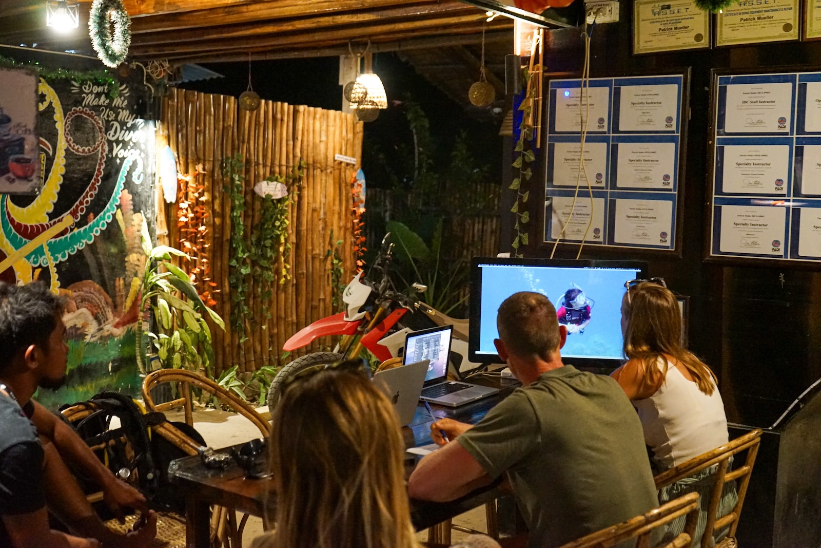 Student completing PADI Open Water theory session at Sunset Divers dive shop in Port Barton, Palawan