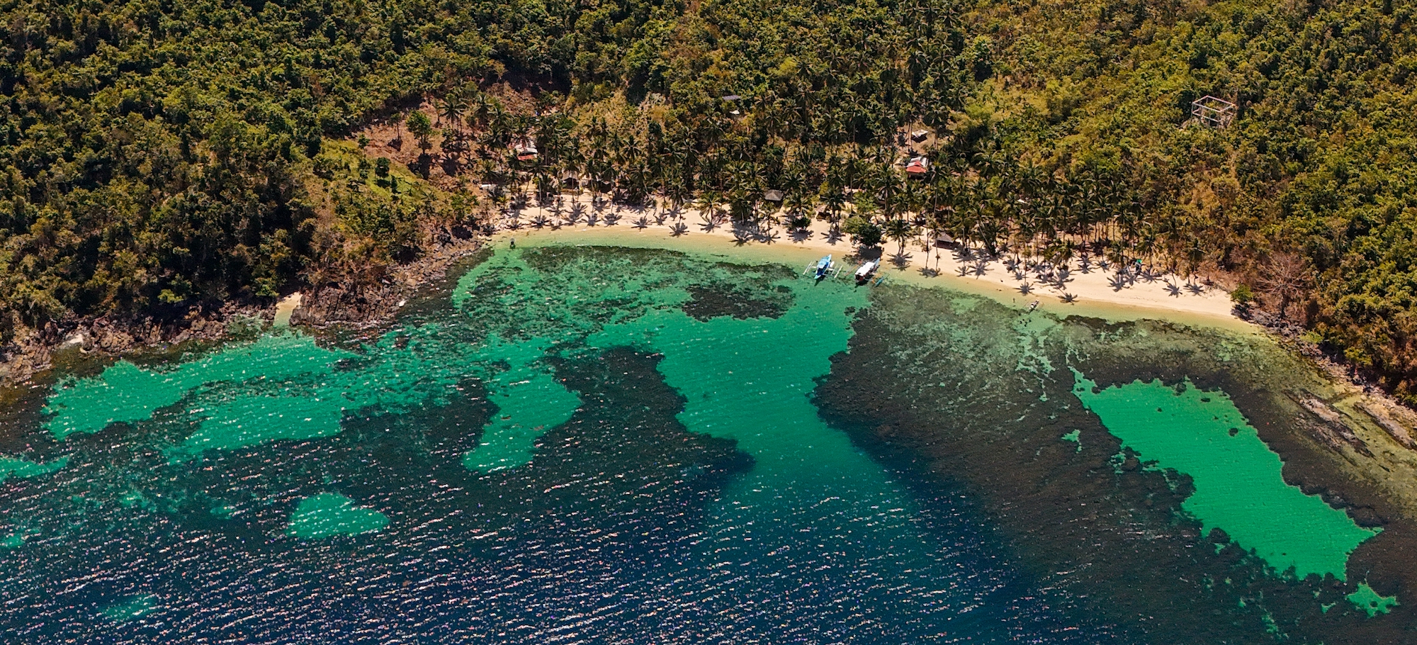Pena Plata island near Port Barton with white sand and clear turquoise water